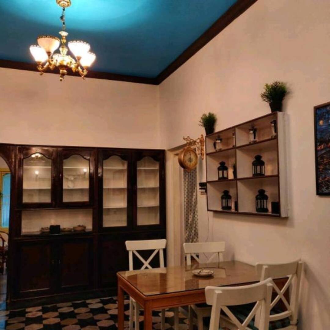 The heirloom dining corner with chandelier and old cupboards