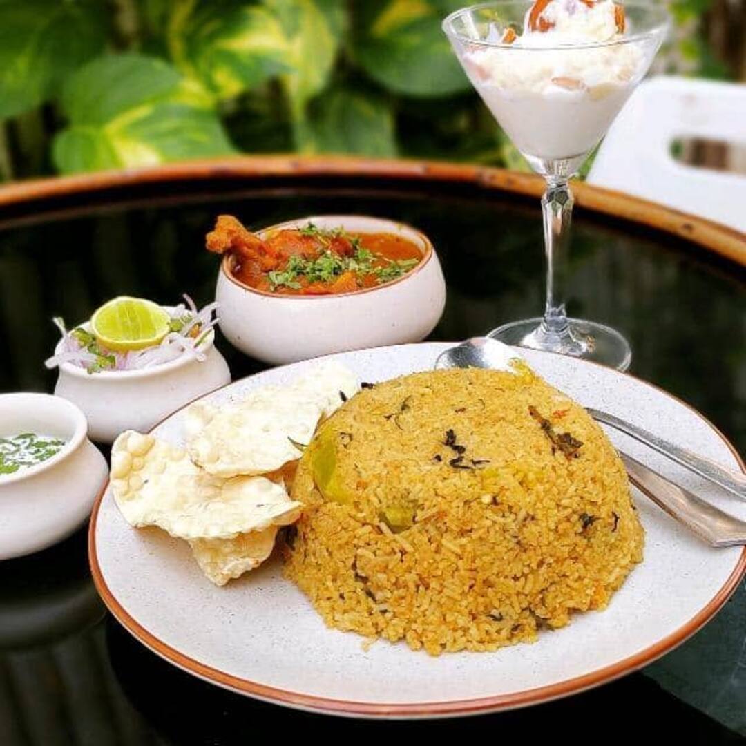 Fried rice platter with schezwan curry and papad